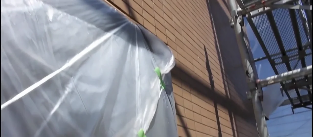 Tile divisions and joints remain visible in the exterior wall coating footage