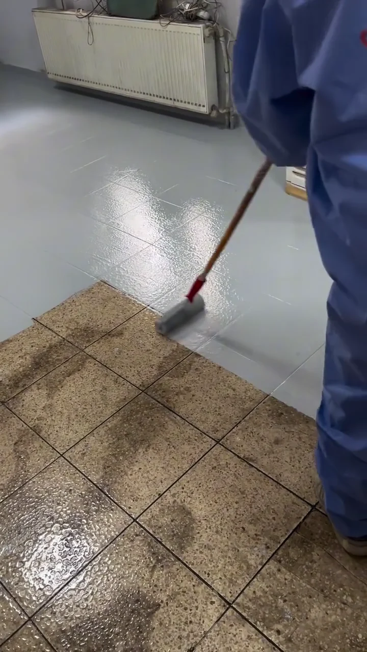 Fresh grey coating next to the still-visible tiled floor